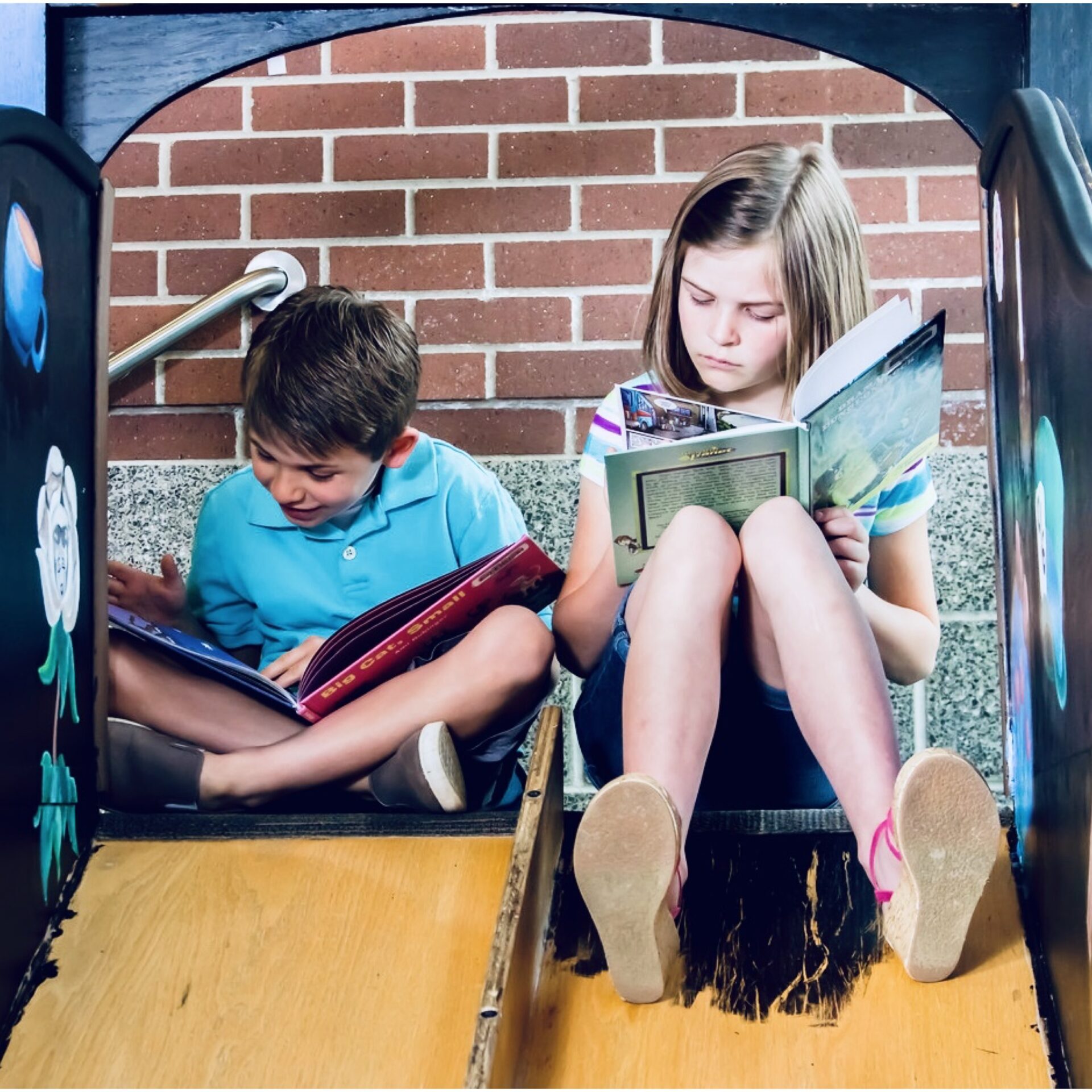 A boy and a girl reading books